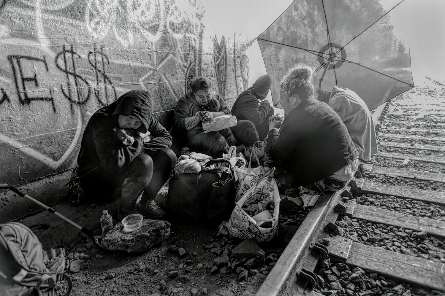 With nowhere to go on Friday, September 15, 2023, five homeless individuals sat at the west end of the 7th Avenue Tunnel that cuts through downtown Olympia, shielded from the sun by a patio umbrella.